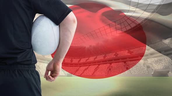 Rugby player holding ball against Japanese flag