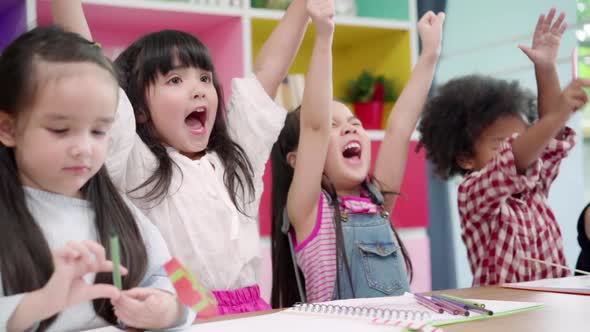 Group of children drawing in classroom, Multi-ethnic young boys and girls happy funny study.