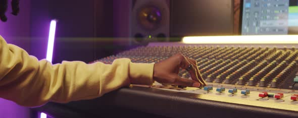 African American Man Working with Mixing Console in Recording Studio