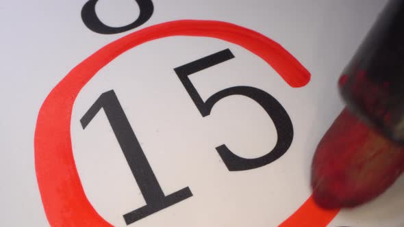 Deadline - day 15 in the calendar. Marking the date in the calendar with a red marker
