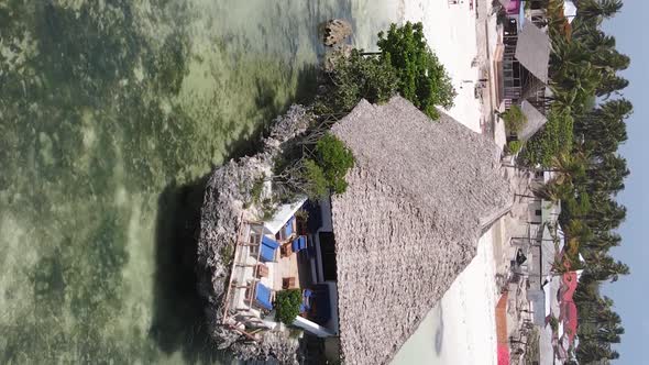 Vertical Video House on Stilts in the Ocean on the Coast of Zanzibar Tanzania Aerial View