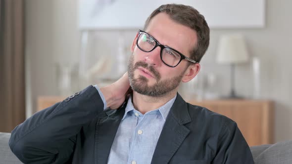 Portrait of Exhausted Young Businessman with Neck Pain