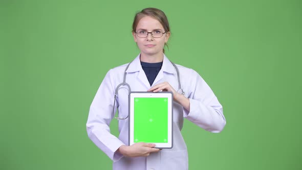 Young Happy Woman Doctor Showing Digital Tablet