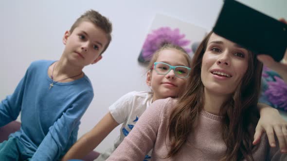 Happy Mother Taking Selfie Photo on Mobile Phone with Kids