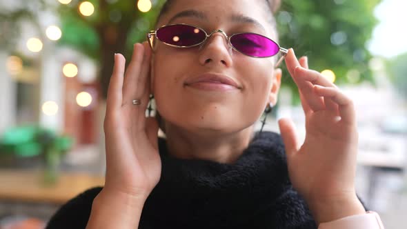 Glamorous White Girl Fooling Around in Outdoor Cafe