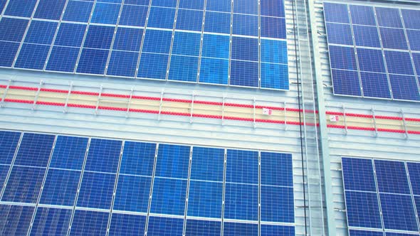 Aerial cinematic view of a solar panel on mall roof top