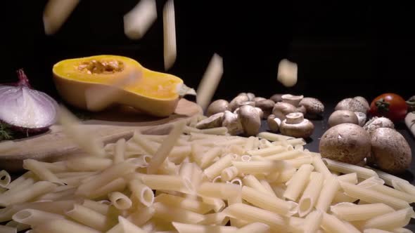 Frying Pan with Raw Pasta Macaroni. Fall in Slow Motion