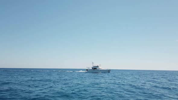 white catamaran sails in the ocean