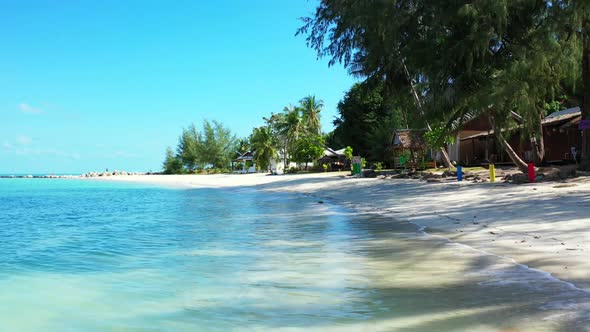 Aerial panorama of exotic resort beach adventure by blue water with white sand background of a dayou