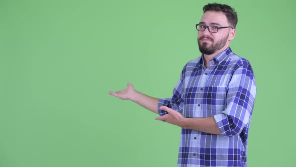 Stressed Young Bearded Hipster Man Showing To the Back