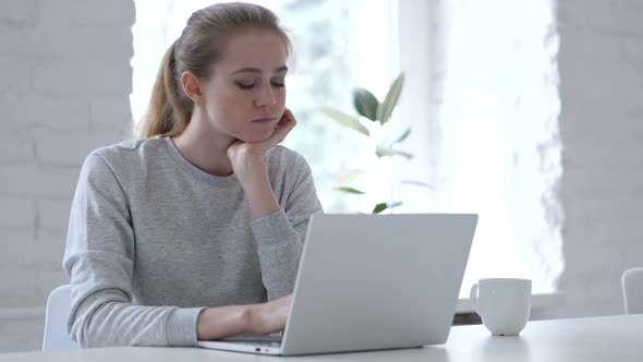 Sad Young Woman Sitting in Office