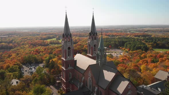 Catholic Church on hillside overlooking fall colored trees in Wisconsin