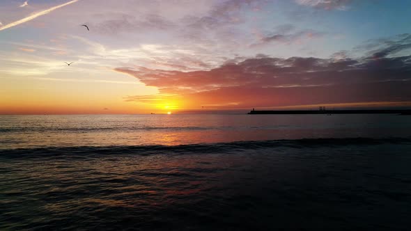 Quiet paradise sunset with yellow sky reflecting over tranquil Sea