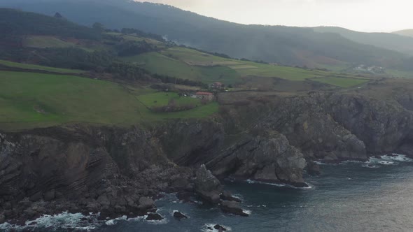 View of Bakio beach resort city and Gaztelugatxe, north rocky coast of Spain at sunset