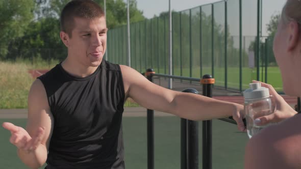 Athlete Talking To Female Friend At Training