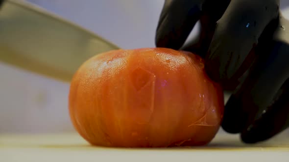 Chef Hands Cut Tomato On A Board