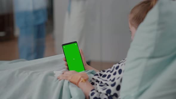 Little Kid Holding Mock Up Green Screen Chroma Key Phone with Isolated Display