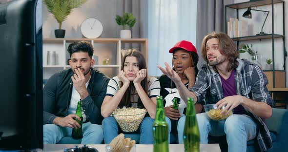 Friends Watching Football Match on TV Set at Home and Dissatisfied from the Game of Favourite Team