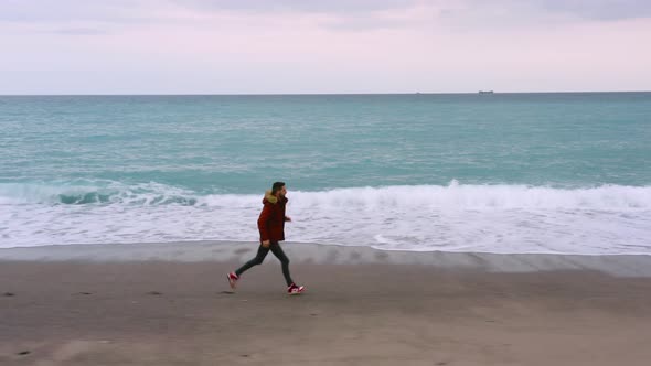 Boy with vest runs on the beach