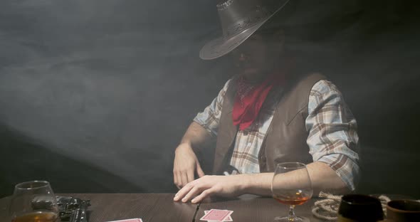 Smokey air in the bar, cowboy with a gun and a cigar is playing poker, 4k