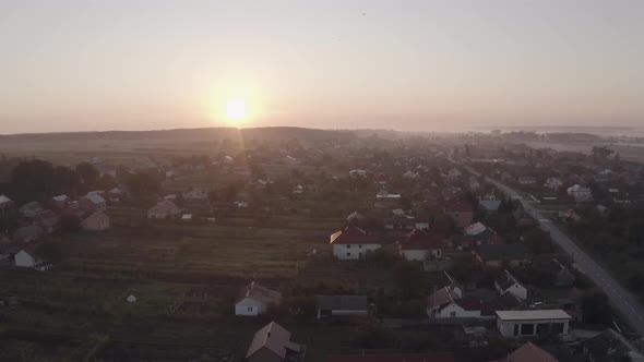 Aerial Drone View Over Old Village at Sunrise. Swallows Birds Flying. Aerial Camera Bird Eye View