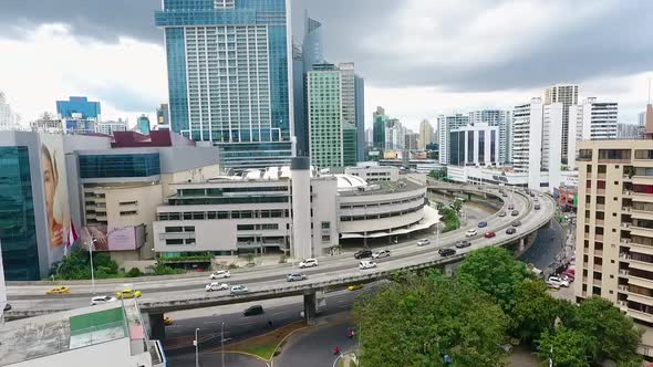 Aerial drone footage in Panama City with highway and bridge in front of buildings