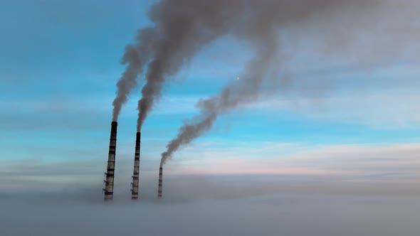 Aerial View of Coal Power Plant High Pipes with Black Smoke Moving Up Polluting Atmosphere at Sunset