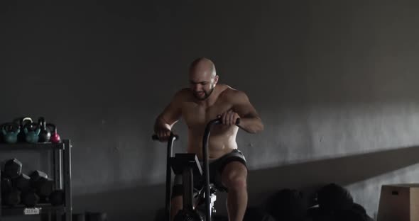 Muscular Sportsman Doing Set of Exercise in Gym