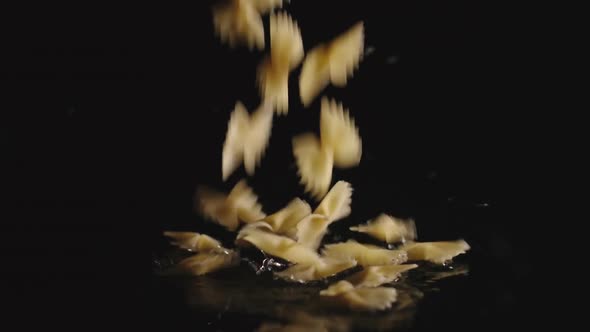 Farfalle pasta fall into water - Slow Motion