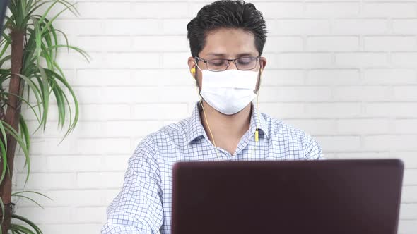 Businessman In a Video Conference Discussing Strategy on Laptop