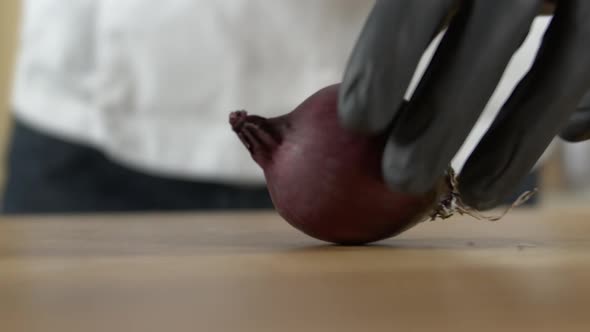 Chef cuts a red onion after turning it on the cutting board, Apple ProRes slow-mo