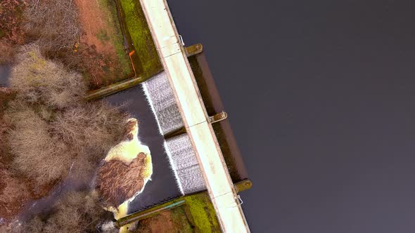 Aerial Birds Eye View Over Road On Encoro de Villasenin Reservoir. Pedestal Up