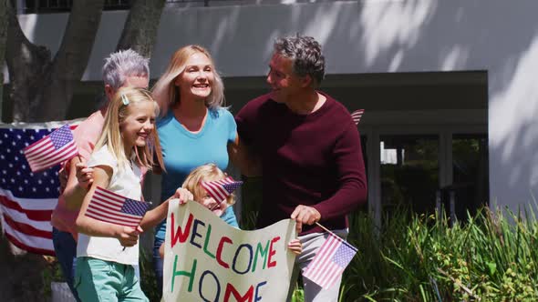 Caucasian military man in uniform hugging his family in the garden