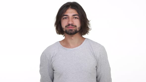 Handsome Longhaired Guy Standing Isolated Over White Background