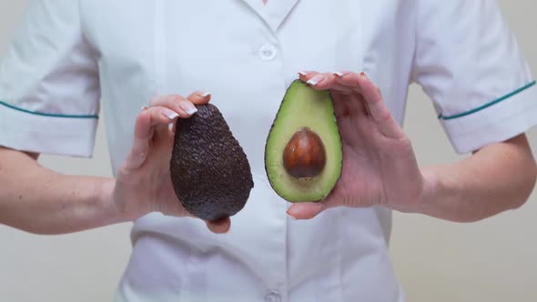 Nutritionist Doctor Healthy Lifestyle Concept - Holding Organic Avocado