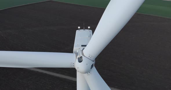 Windmill Rotor Blades Turn and Produce Green Energy, Aerial Descending Shot