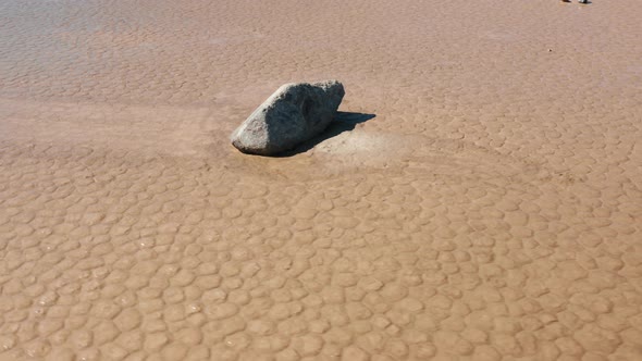 Scenic Close Up View of Rock on the Wet Cracked Surface of Death Valley Desert