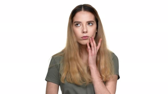 Portrait of Thoughtful Woman in Casual Tshirt Reflecting or Doubting Isolated Over White Background