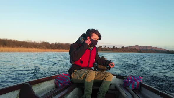 Young man boat ring mask fleeing Corona virus pandemic wilderness 4K