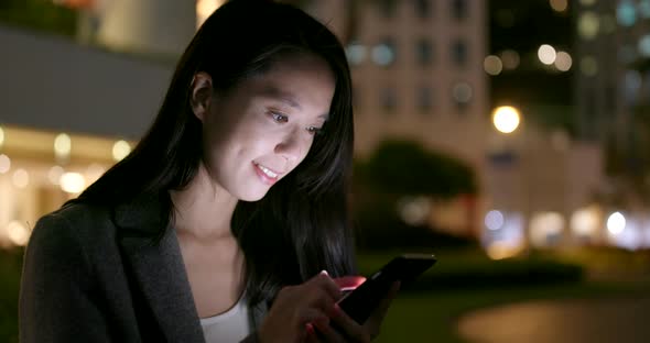 Woman Read on Smart Phone in City