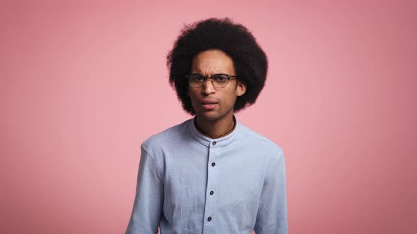 Video of young African man looking at something in studio shot