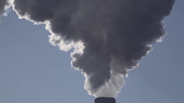 Smoke Stack with a Nice Smoke Over Blue Sky