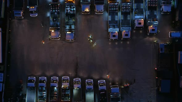 Aerial View of Roadworks Depot at Night With Vehicles and Workers