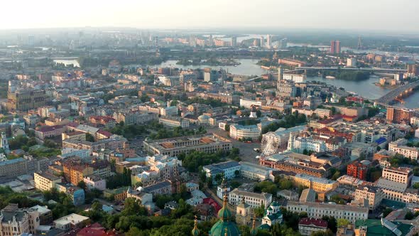 Top view of Podol. Many buildings and churches. Evening view of the river Dnipro.