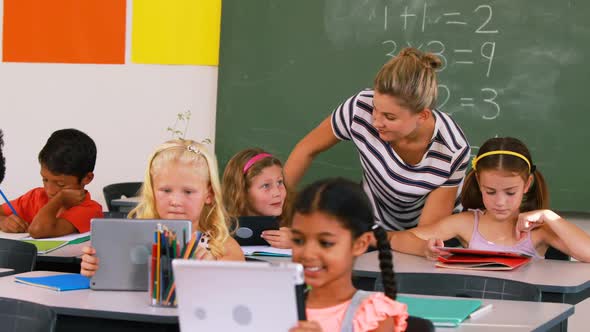 Teacher teaching kids on digital tablet