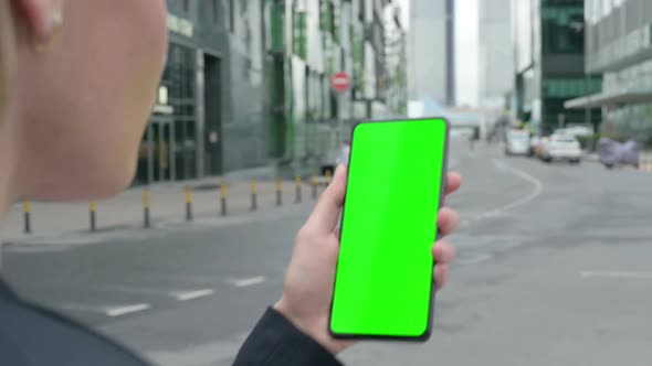 Businesswoman Using Smartphone with Green Chroma Screen