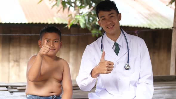 Male Doctor With Little Patient Showing Thumbs Up