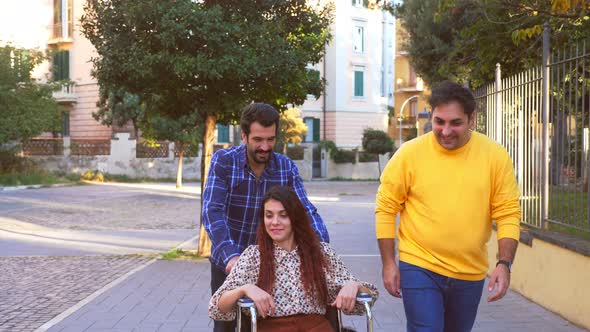 caring men push the wheelchair of their young friend with a disability