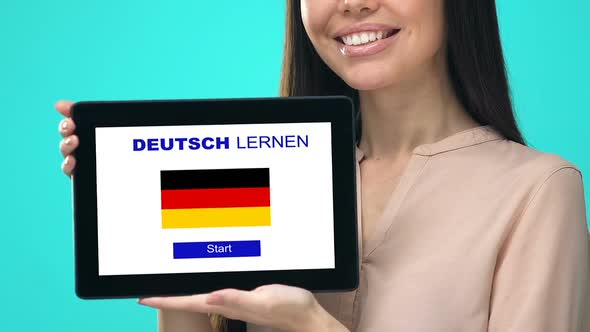 Happy Female Holding Tablet With Learn German Language Test, Educational App