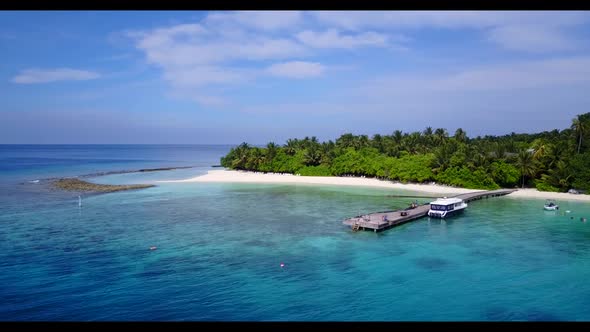 Aerial top view scenery of idyllic lagoon beach holiday by shallow ocean with white sandy background